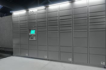 a row of automated lockers with a green screen